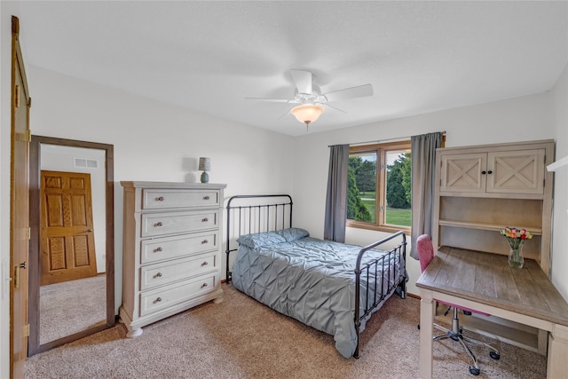 904 Pleasant St SE, Bondurant, IA 50035 - bedroom featuring light carpet, a ceiling fan, and a desk
