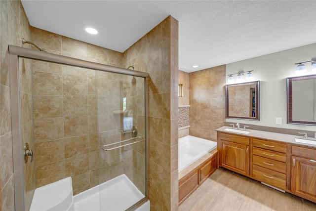 904 Pleasant St SE, Bondurant, IA 50035 - bathroom featuring a stall shower, a garden tub, and double vanity