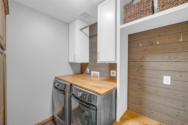 904 Pleasant St SE, Bondurant, IA 50035 - washroom featuring cabinet space, independent washer and dryer, and light wood-type flooring