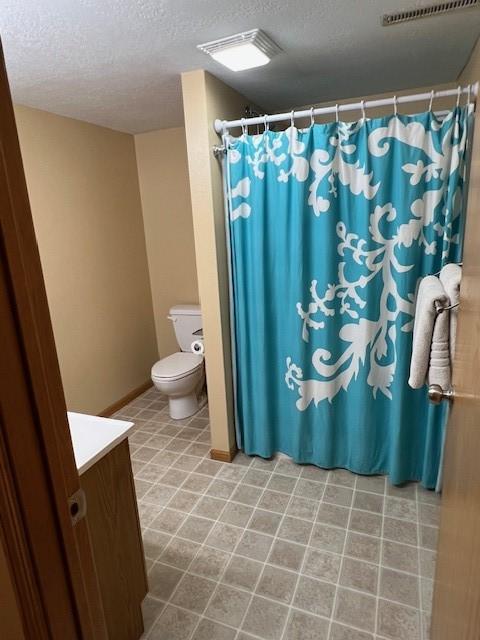 4806 Waller St, Ames, IA 50014 - bathroom with a textured ceiling, vanity, and a shower with curtain