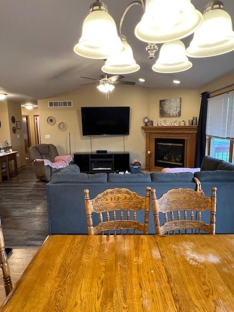 4806 Waller St, Ames, IA 50014 - dining space featuring a glass covered fireplace, a ceiling fan, wood finished floors, and lofted ceiling