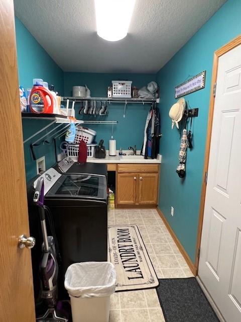 4806 Waller St, Ames, IA 50014 - washroom with independent washer and dryer, light tile patterned floors, a textured ceiling, and cabinet space