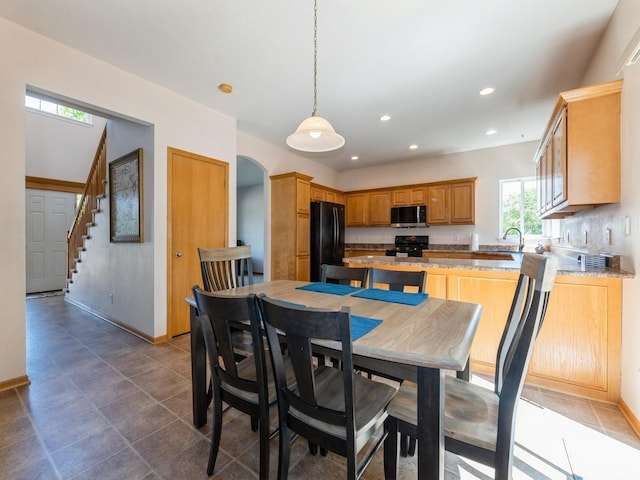 705 SE Whitetail Ln, Waukee, IA 50263 - tiled dining room with stairs, recessed lighting, and arched walkways
