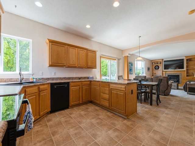705 SE Whitetail Ln, Waukee, IA 50263 - kitchen featuring black dishwasher, a glass covered fireplace, open floor plan, a peninsula, and recessed lighting