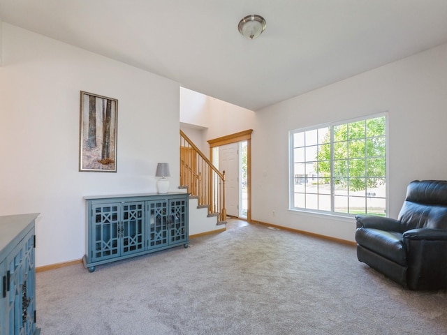 705 SE Whitetail Ln, Waukee, IA 50263 - living area featuring stairway and carpet flooring