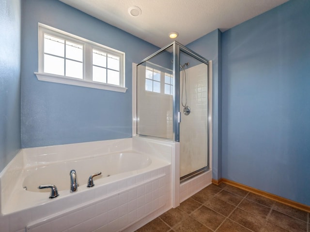 705 SE Whitetail Ln, Waukee, IA 50263 - full bathroom featuring a bath, a stall shower, and tile patterned flooring