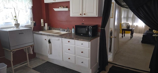 1924 4th St, Perry, IA 50220 - kitchen with black microwave, white cabinetry, open shelves, and dark countertops