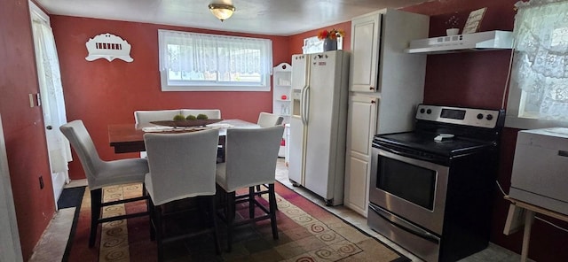 1924 4th St, Perry, IA 50220 - kitchen featuring electric range, white refrigerator with ice dispenser, under cabinet range hood, and open shelves