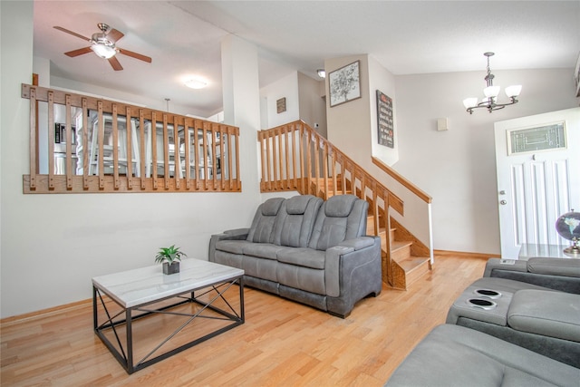 5420 SW 13th St, Des Moines, IA 50315 - living area featuring wood finished floors, a chandelier, stairs, and ceiling fan