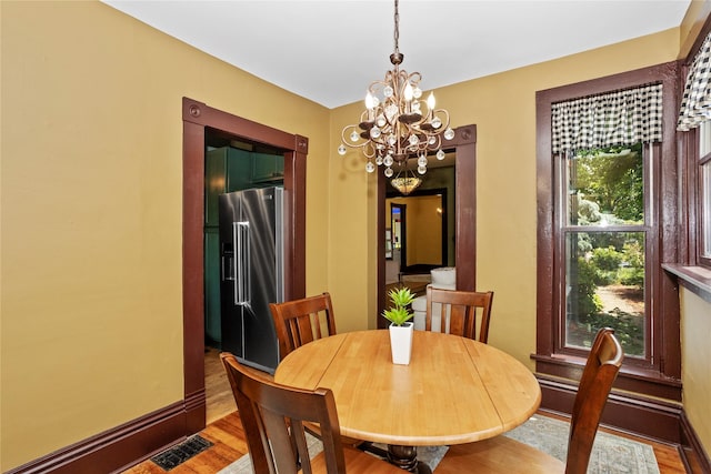 658 20th St, Des Moines, IA 50314 - dining room with a chandelier and wood finished floors