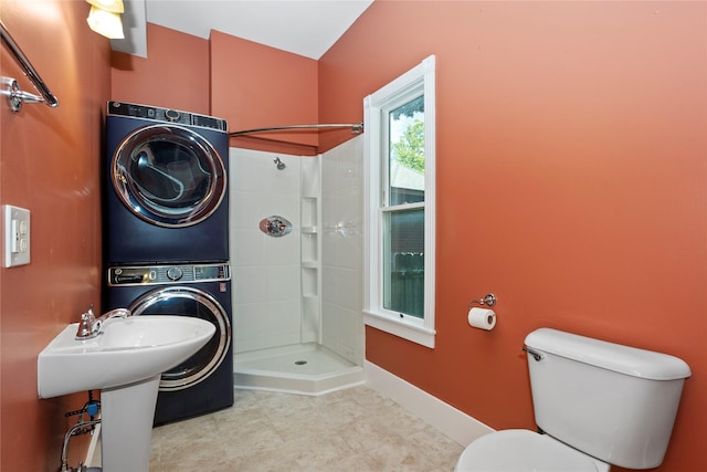 658 20th St, Des Moines, IA 50314 - bathroom with estacked washer and dryer and a tile shower