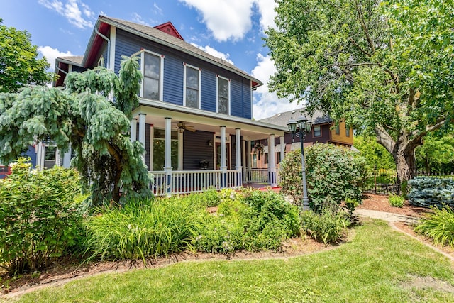 658 20th St, Des Moines, IA 50314 - traditional style home featuring covered porch, a ceiling fan, and a front yard