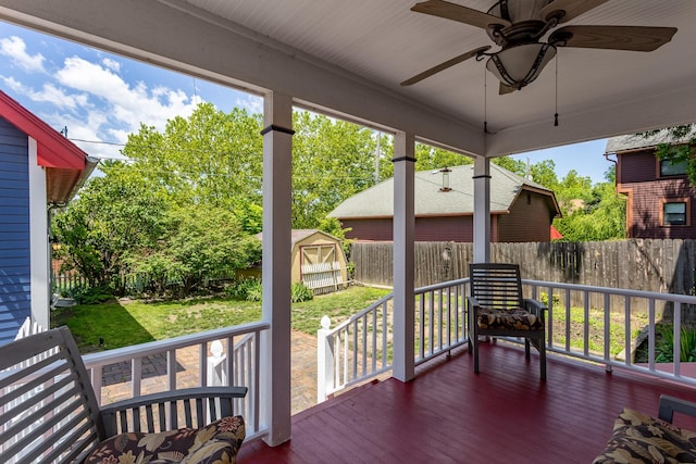 658 20th St, Des Moines, IA 50314 - wooden deck with a fenced backyard, a ceiling fan, and a shed