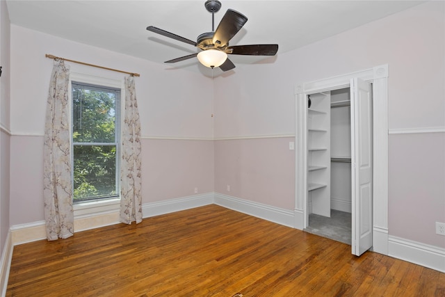 658 20th St, Des Moines, IA 50314 - unfurnished bedroom with wood finished floors and ceiling fan