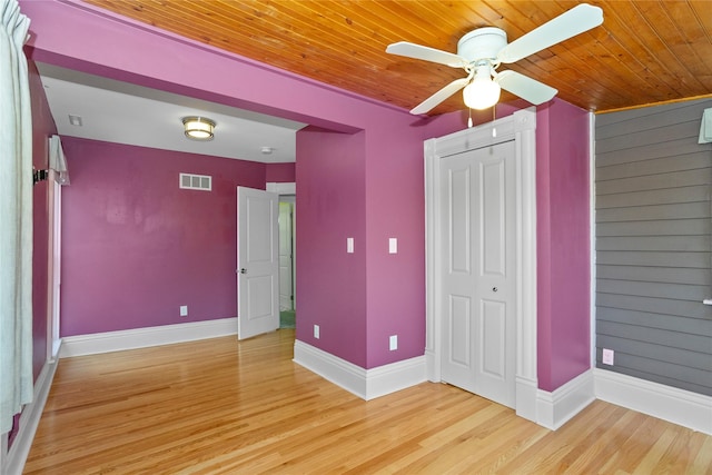 658 20th St, Des Moines, IA 50314 - unfurnished bedroom featuring wooden ceiling, light wood-style flooring, ceiling fan, and a closet