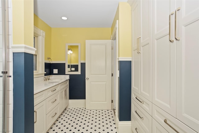 658 20th St, Des Moines, IA 50314 - kitchen featuring light stone countertops and white cabinetry
