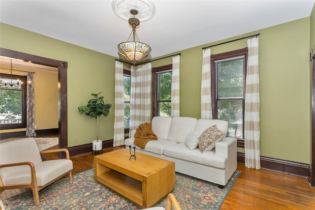 658 20th St, Des Moines, IA 50314 - living room with a chandelier and wood finished floors