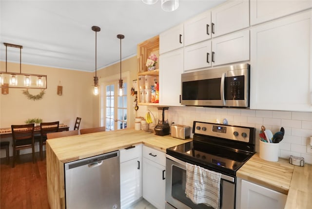 618 Arthur Ave, Des Moines, IA 50313 - kitchen featuring stainless steel appliances, wood counters, a peninsula, white cabinets, and ornamental molding
