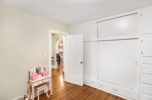 618 Arthur Ave, Des Moines, IA 50313 - bedroom with arched walkways, wood finished floors, and a closet