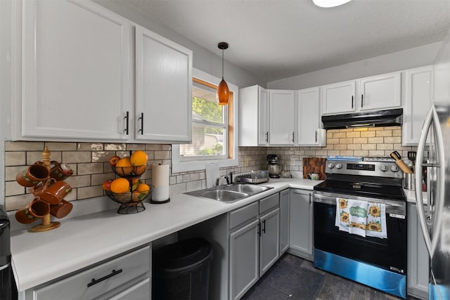 1324 College Ave, Des Moines, IA 50314 - kitchen featuring stainless steel electric range oven, under cabinet range hood, light countertops, white cabinets, and decorative backsplash