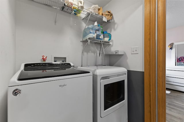 1324 College Ave, Des Moines, IA 50314 - laundry room featuring separate washer and dryer and wood finished floors