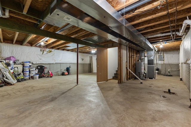 1324 College Ave, Des Moines, IA 50314 - unfinished basement with stairs, gas water heater, and heating unit