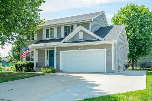 550 25th St SE, Altoona, IA 50009 - view of front of property with a garage, driveway, a shingled roof, and covered porch