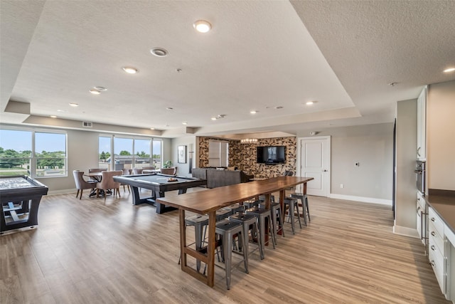 9065 Bishop Dr Unit 314, West Des Moines, IA 50266 - dining space with light wood finished floors, a textured ceiling, and recessed lighting