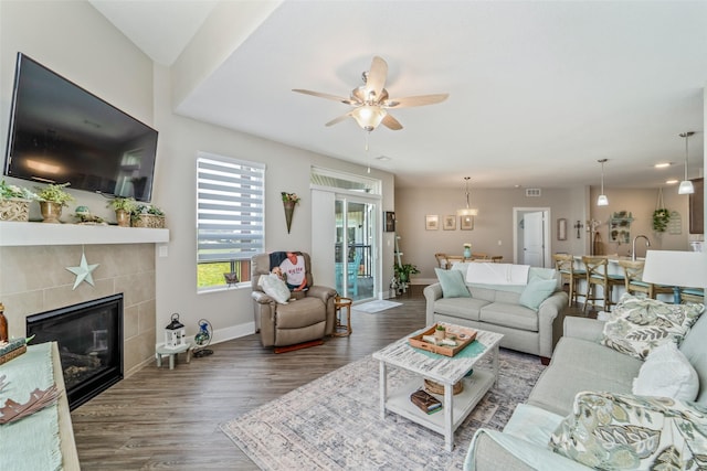 9065 Bishop Dr Unit 314, West Des Moines, IA 50266 - living area with wood finished floors, ceiling fan, and a tiled fireplace