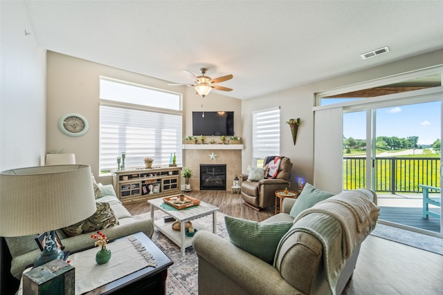 9065 Bishop Dr Unit 314, West Des Moines, IA 50266 - living room featuring wood finished floors, ceiling fan, and a fireplace