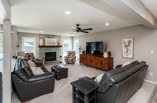 2507 135th St, Urbandale, IA 50323 - living room with light carpet, plenty of natural light, recessed lighting, a stone fireplace, and ceiling fan