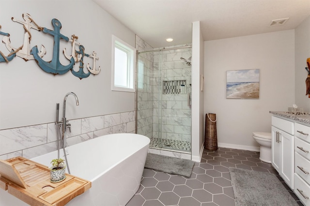 2507 135th St, Urbandale, IA 50323 - bathroom featuring vanity, a freestanding tub, a shower stall, and tile patterned floors