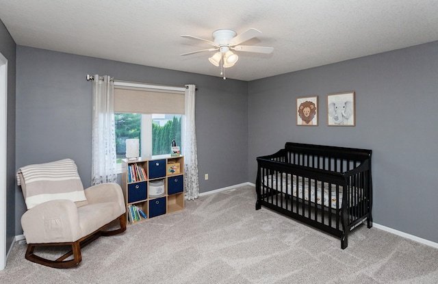 2507 135th St, Urbandale, IA 50323 - bedroom featuring carpet flooring, a crib, and a ceiling fan