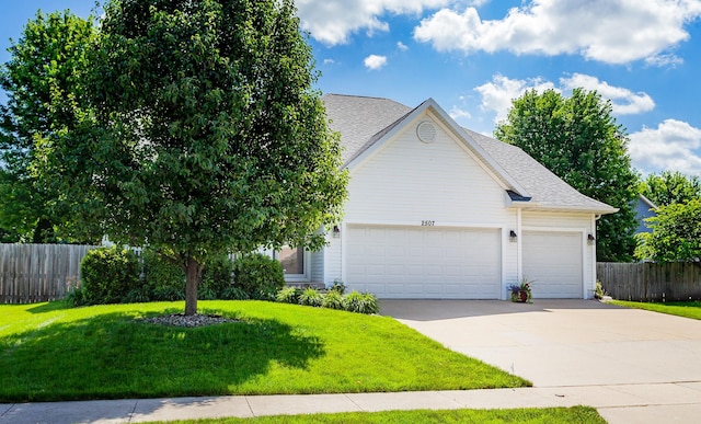 2507 135th St, Urbandale, IA 50323 - view of front of house featuring a garage, driveway, and roof with shingles