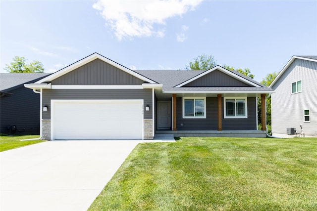 2529 SE Integra Ave, West Des Moines, IA 50265 - view of front of home featuring a garage, concrete driveway, a front lawn, a porch, and a shingled roof