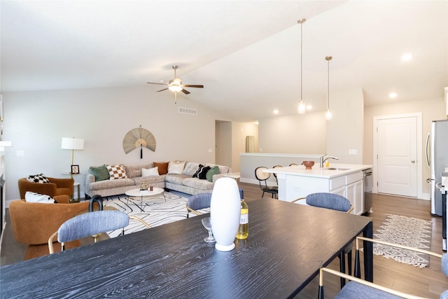 2529 SE Integra Ave, West Des Moines, IA 50265 - dining room featuring dark wood-style flooring, ceiling fan, lofted ceiling, and recessed lighting