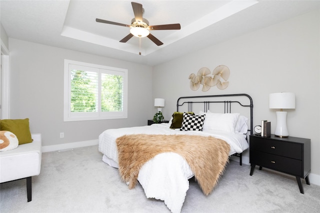 2529 SE Integra Ave, West Des Moines, IA 50265 - bedroom with light carpet, a raised ceiling, and ceiling fan