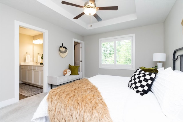2529 SE Integra Ave, West Des Moines, IA 50265 - bedroom with a raised ceiling, carpet, ensuite bathroom, and ceiling fan