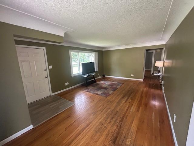 3412 Crestmoor Pl, Des Moines, IA 50310 - unfurnished living room with a textured ceiling and wood finished floors