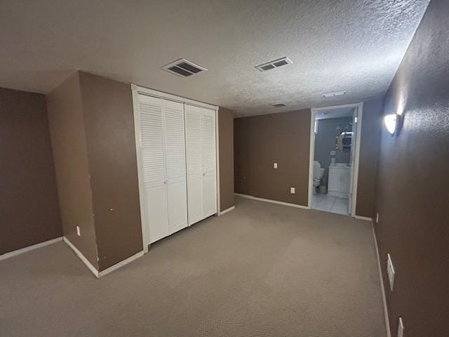 3412 Crestmoor Pl, Des Moines, IA 50310 - unfurnished bedroom featuring carpet flooring, a closet, a textured ceiling, and ensuite bath