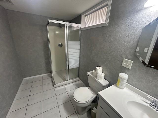3412 Crestmoor Pl, Des Moines, IA 50310 - bathroom featuring a stall shower, tile patterned floors, vanity, and a textured wall