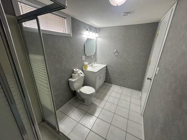 3412 Crestmoor Pl, Des Moines, IA 50310 - full bathroom with vanity, tile patterned floors, a stall shower, and a textured wall