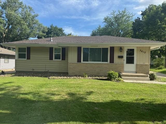 3412 Crestmoor Pl, Des Moines, IA 50310 - view of front of home with brick siding, board and batten siding, and a front lawn