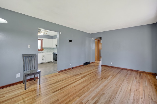 2704 Wedgewood Rd, Des Moines, IA 50317 - unfurnished living room with light wood finished floors and a ceiling fan