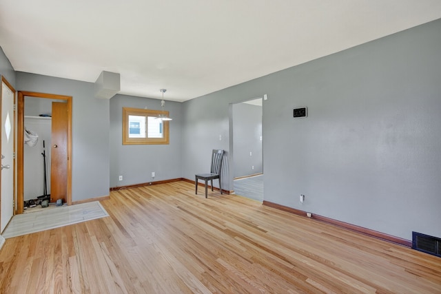 2704 Wedgewood Rd, Des Moines, IA 50317 - empty room featuring light wood finished floors and a chandelier