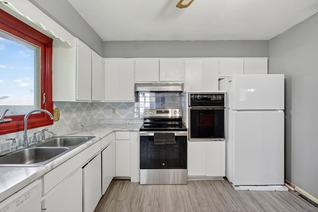 2704 Wedgewood Rd, Des Moines, IA 50317 - kitchen featuring white appliances, under cabinet range hood, light countertops, white cabinets, and light wood-type flooring