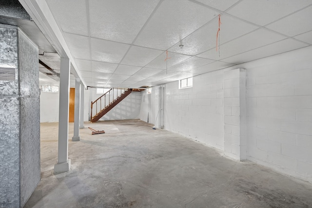 2704 Wedgewood Rd, Des Moines, IA 50317 - below grade area featuring stairway, a paneled ceiling, and concrete block wall