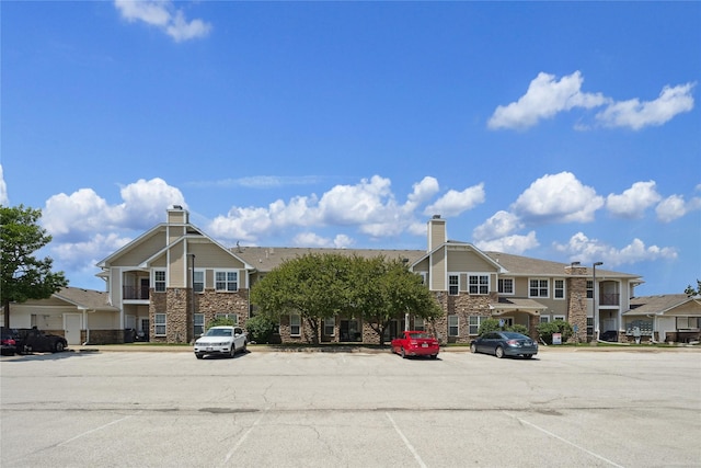 1313 SE University Ave Unit 206, Waukee, IA 50263 - view of property with uncovered parking and a residential view