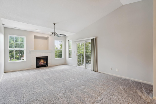 1313 SE University Ave Unit 206, Waukee, IA 50263 - unfurnished living room with carpet floors, ceiling fan, vaulted ceiling, and a tiled fireplace