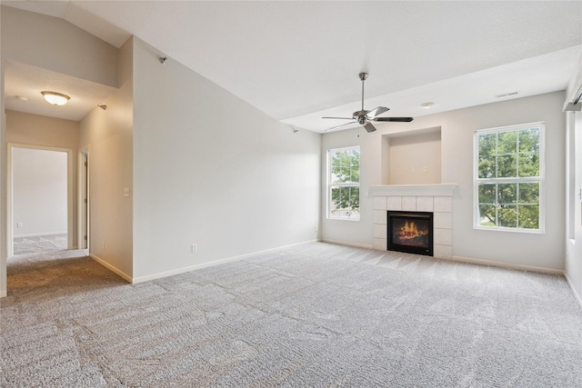 1313 SE University Ave Unit 206, Waukee, IA 50263 - unfurnished living room featuring a ceiling fan, carpet floors, healthy amount of natural light, vaulted ceiling, and a fireplace